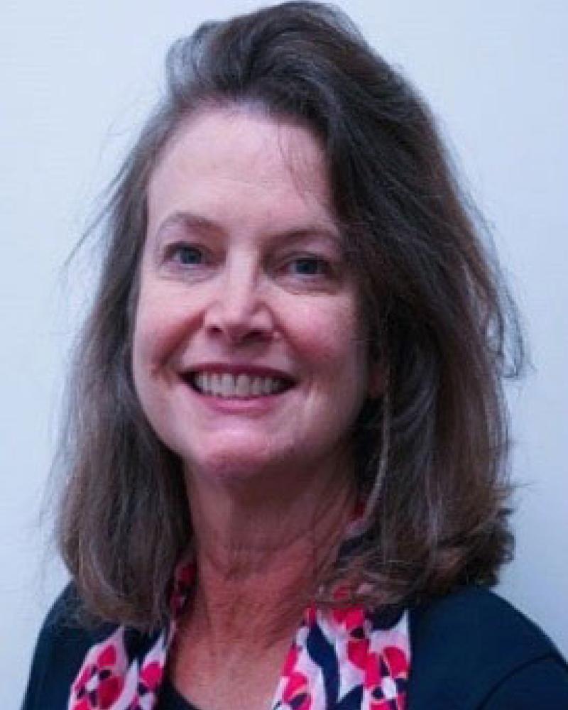 Dr. Catherine Hall smiling and wearing a scarf
