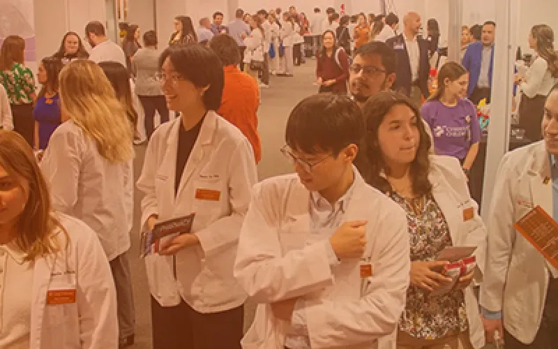 Pharm.D. students attending a career fair and wearing white coats