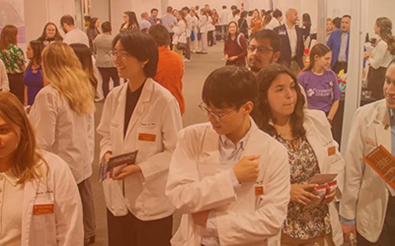 Pharm.D. students attending a career fair and wearing white coats
