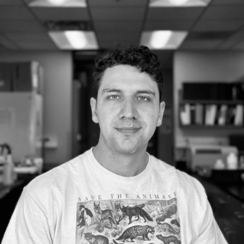 Steven Guerin smiling and wearing a white t-shirt