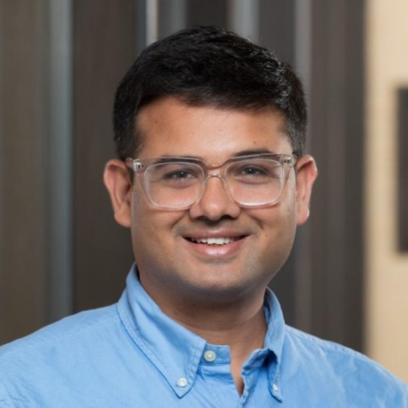 Narayan Acharya smiling in the Pharmacy building