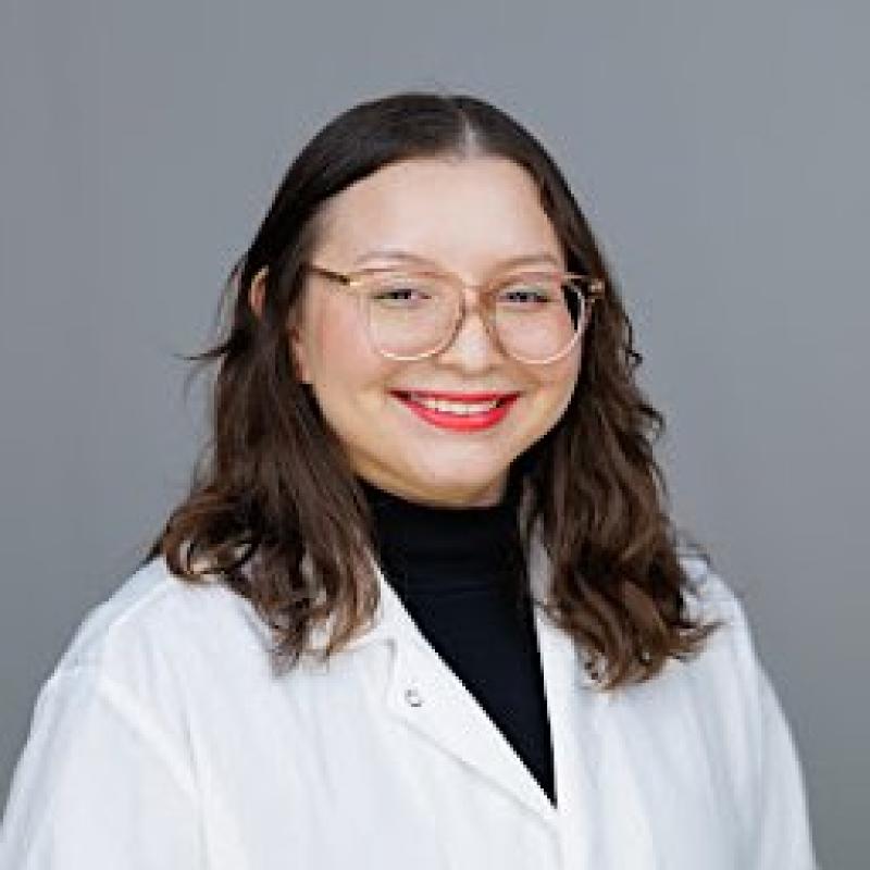 Dr. Astrid Cardona Acosta smiling in an indoor setting