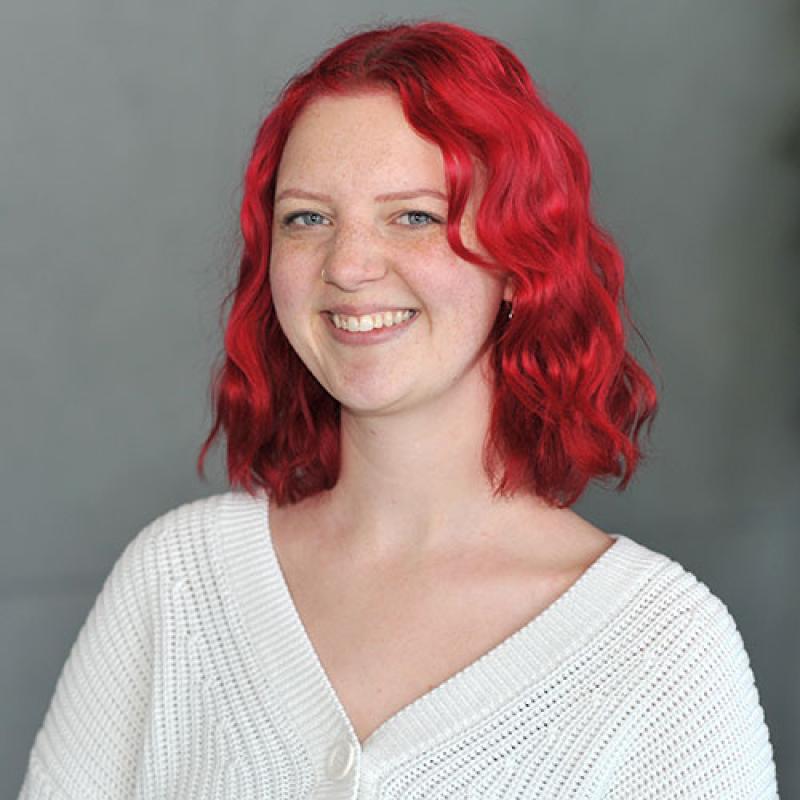 Nadia McLean smiling and wearing a white sweater